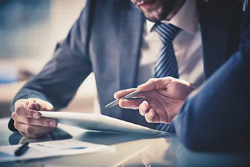 image of two people using a tablet to discuss work 