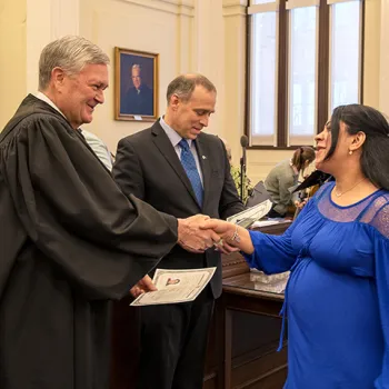 Senior Judge D. Brock Hornby gives a certificate of citizenship. 