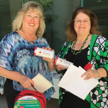 People hold emergency kits that were available at the fairs.