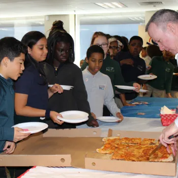 In Hartford, Connecticut, Tom Ring, law clerk to Senior District Judge Dominic J. Squatrito, hands out pizza to students of the Robert J. O'Brien STEM Academy.