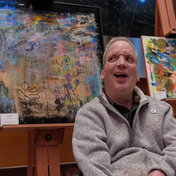 Artist Bill Crane poses in front of his artwork on display at the Diana E. Murphy U.S. Courthouse in Minneapolis.