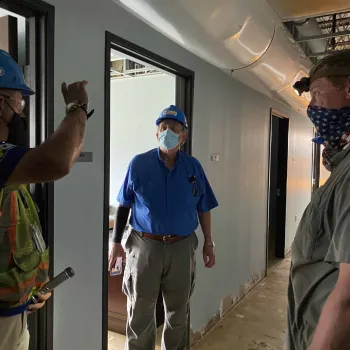 S. Maurice “Maury” Hicks (center, in blue shirt), chief Judge of the Western District of Louisiana, inspects the damaged Lake Charles courthouse. 