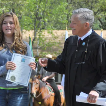 Michael J. Seng, a magistrate judge based within Yosemite National Park, congratulates essay contest winner Lilly Lessley.  