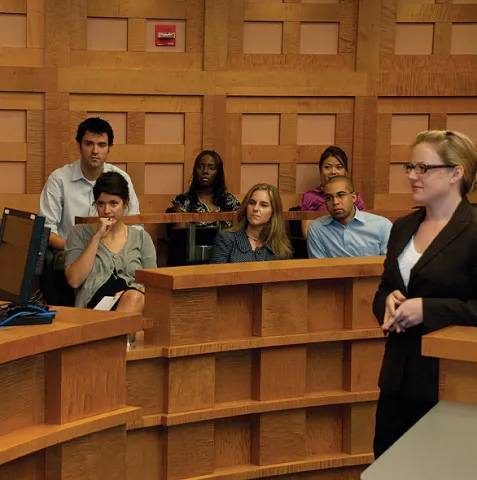 Image of a courtroom, lawyer, and jury.