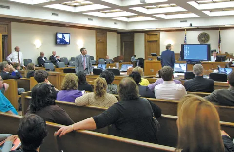 TJ Haycox (center) of the Western District of North Carolina demonstrates the Jury Evidence Recording System (JERS) for participants at the FJC National Juror and Management Utilization Program.