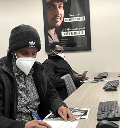 Two people in a classroom setting at a Minneapolis-based trucking school.