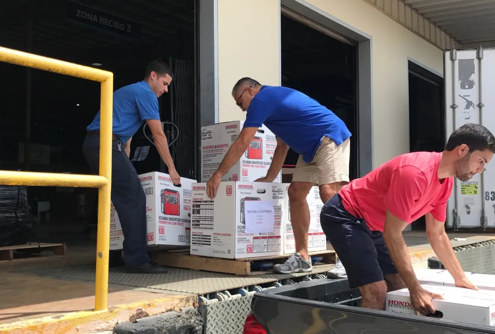 Court staff unloading generators. 