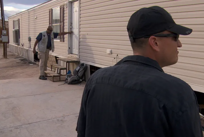 Probation officers conduct a home visit.