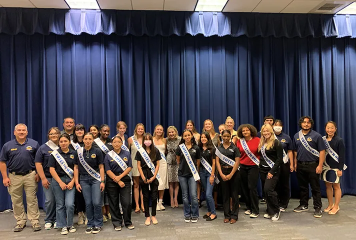 Students wear 19th Amendment sashes celebrating women’s suffrage at a reading of the Constitution at the federal courthouse in Sacramento.